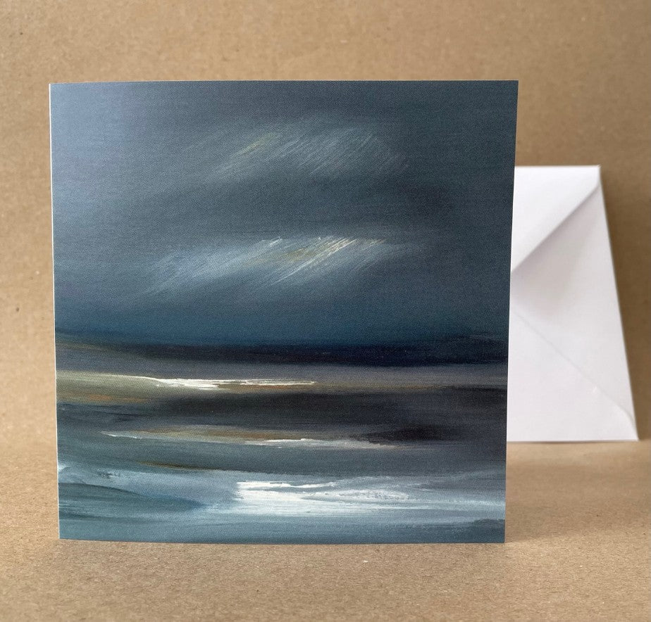 Square greeting card with envelope. The image is a seascape with rocks and sand in the foreground.