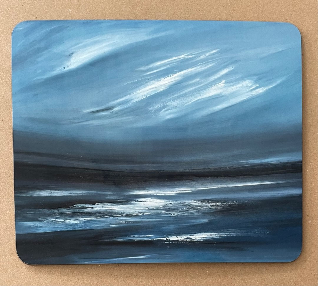 Placemat with a printed image of a rocky foreground and Ailsa Craig in the distance.