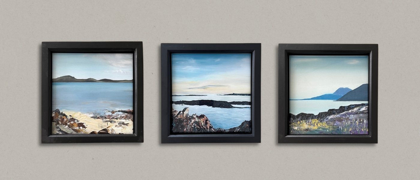 Three black-framed prints of Hebridean scenes.