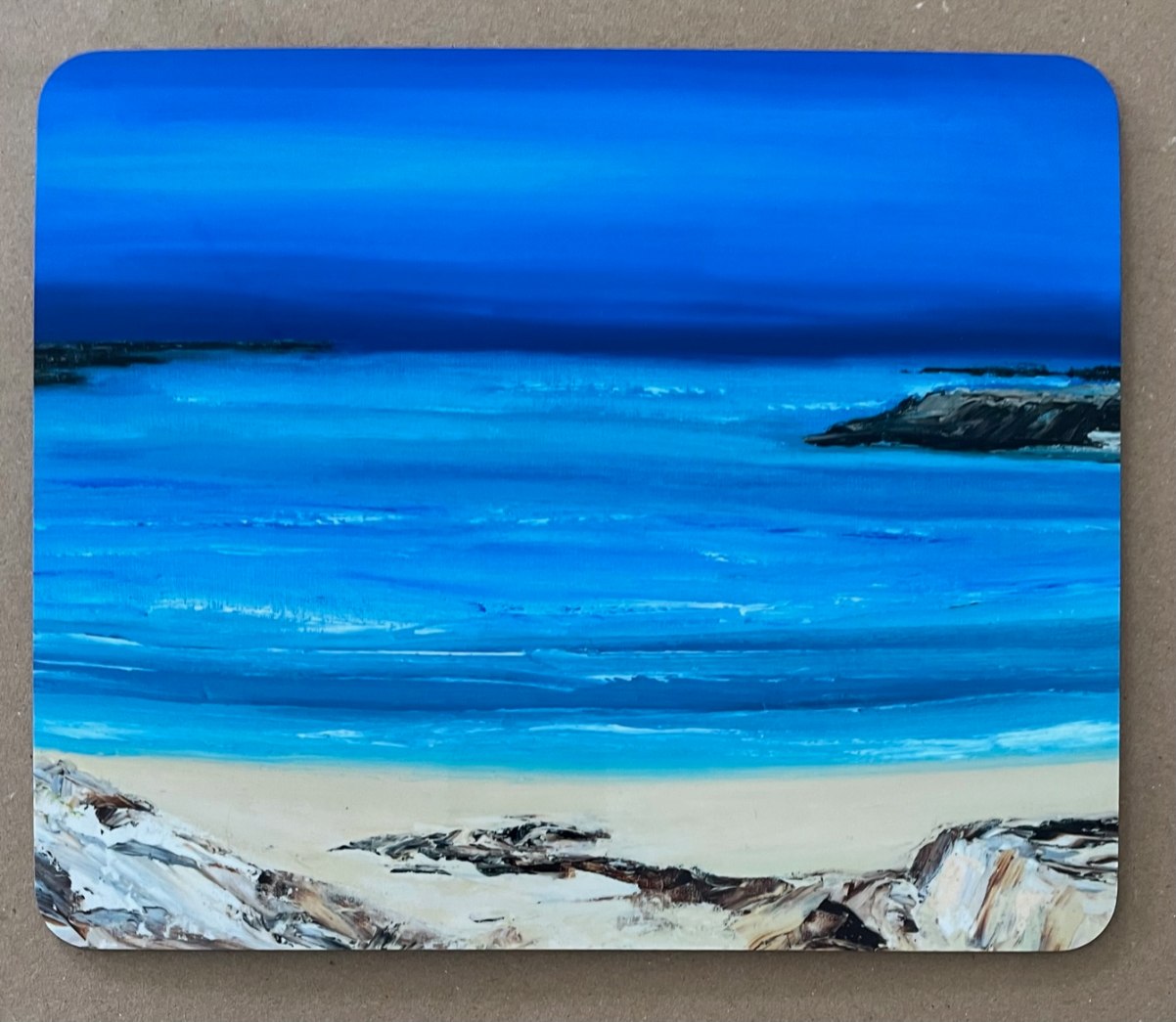 Placemat with a Hebridean seascape painting.