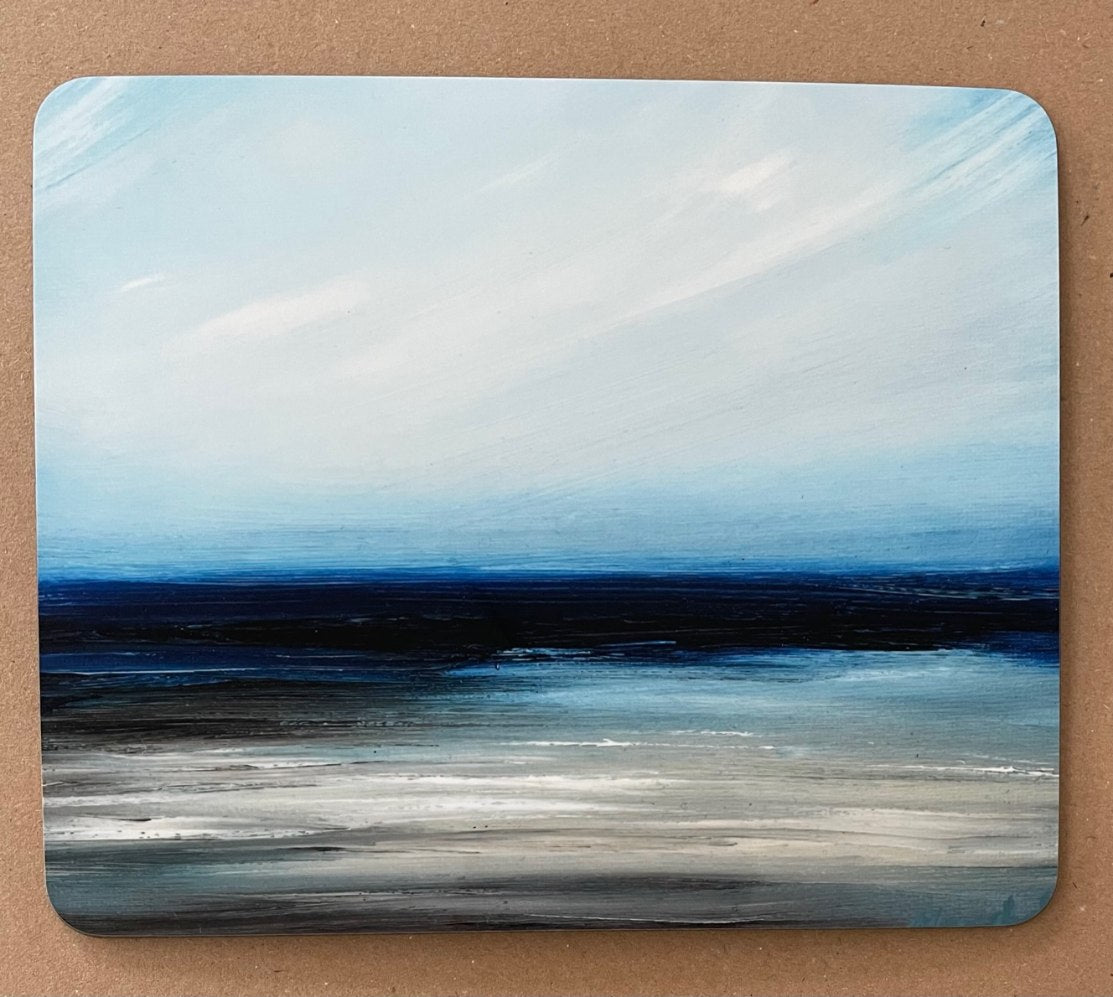 Placemat with a printed image of a white Hebrides sandy beach and azure sea and sky.