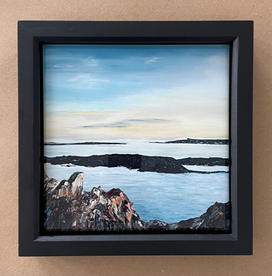 Rocky Scottish seascape print in black frame.