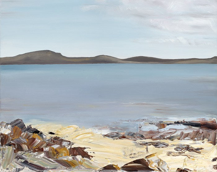 Printed image of a rocky, sandy beach in the foreground and sea and grey hills beyond.
