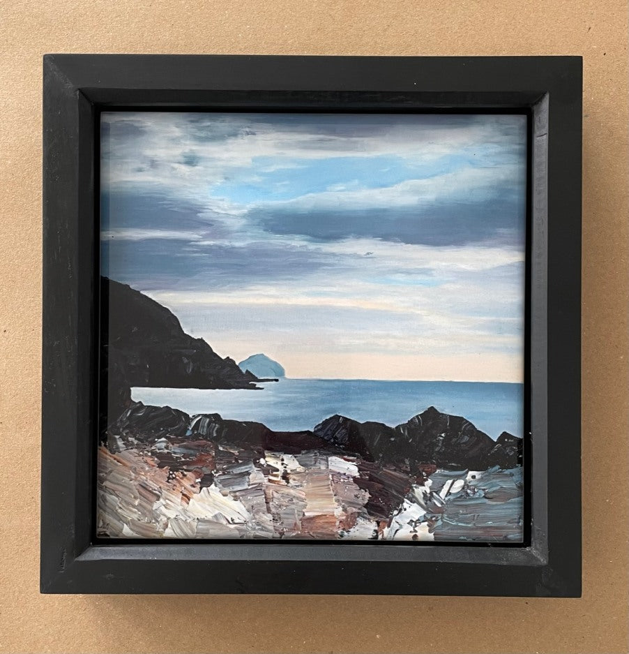 Black-framed printed tile of a view from a rocky Ayrshire coast across to Ailsa Craig.